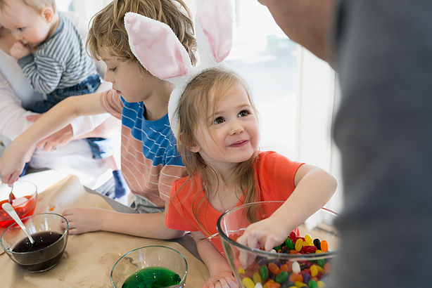 Cute daughter in bunny ears smiling up father